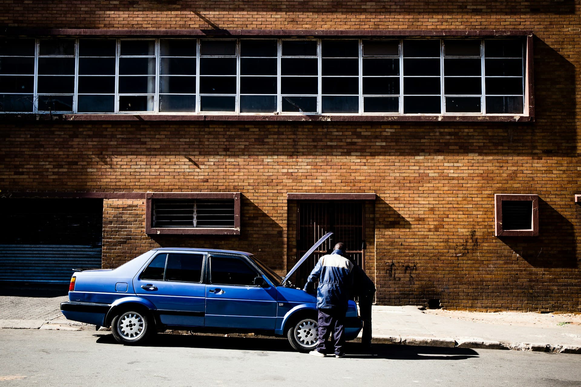 Mechanic inspecting car engine